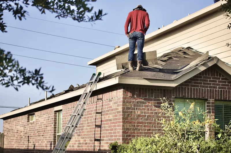 Professional roofer working on a residential roof in New Sharon
